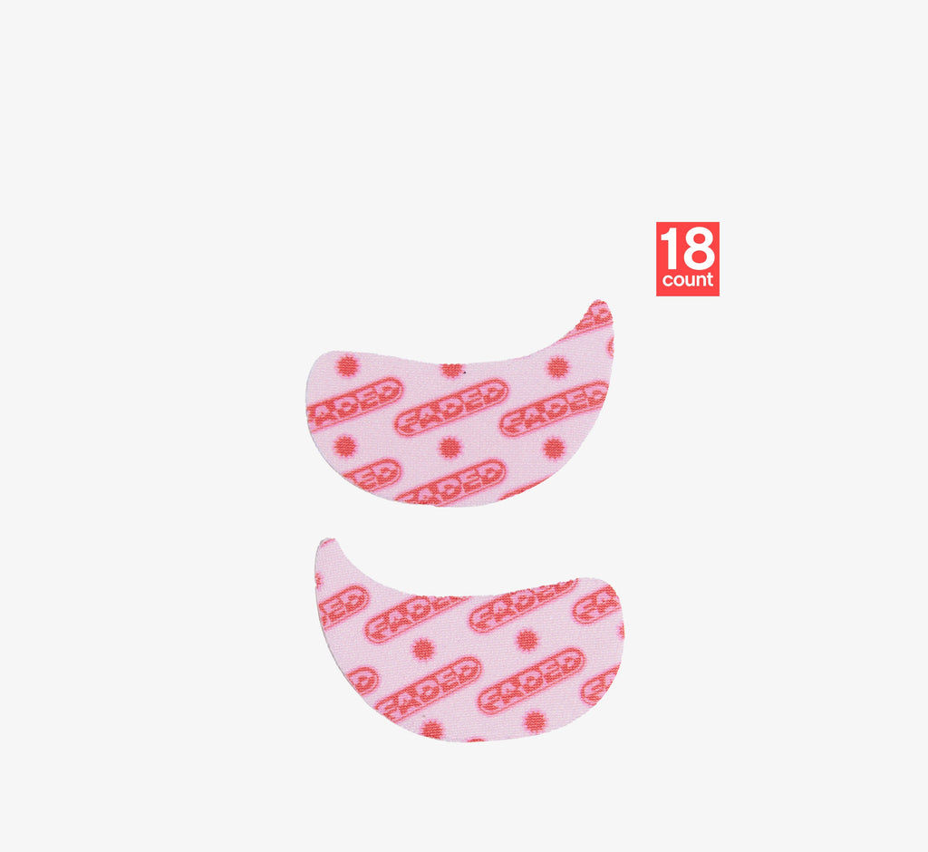Under eye brightening patches from Topicals Faded featuring a pink-and-red branded print, shown as a close-up pair from an 18-count pack.